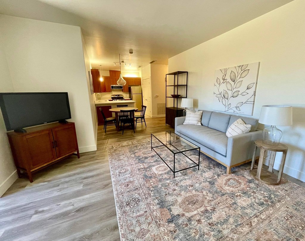 a living room with a couch and a tv  at Polo Villas, Bakersfield, 93312